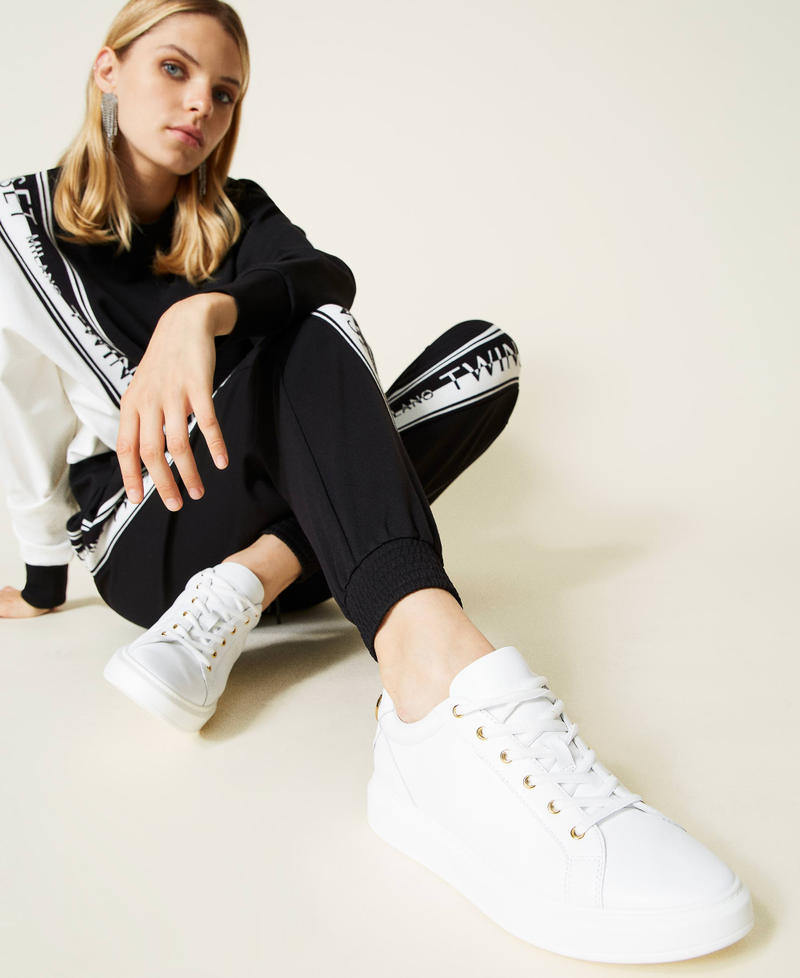 Leather trainers with rhinestone logo