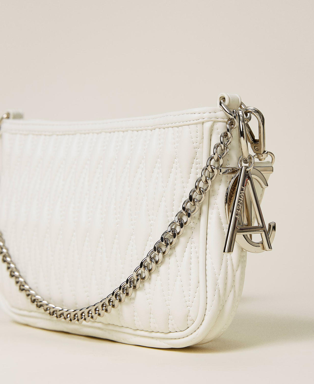 Quilted bag with chain and charms