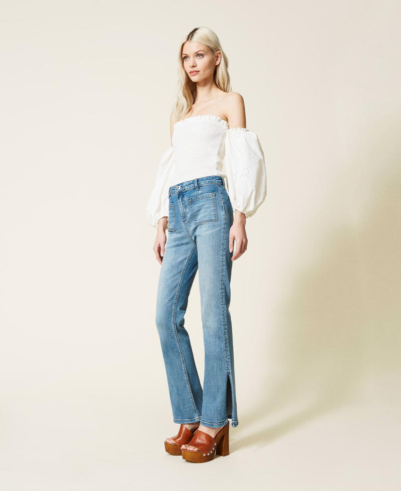 Flared jeans with appliqu&eacute;d pockets