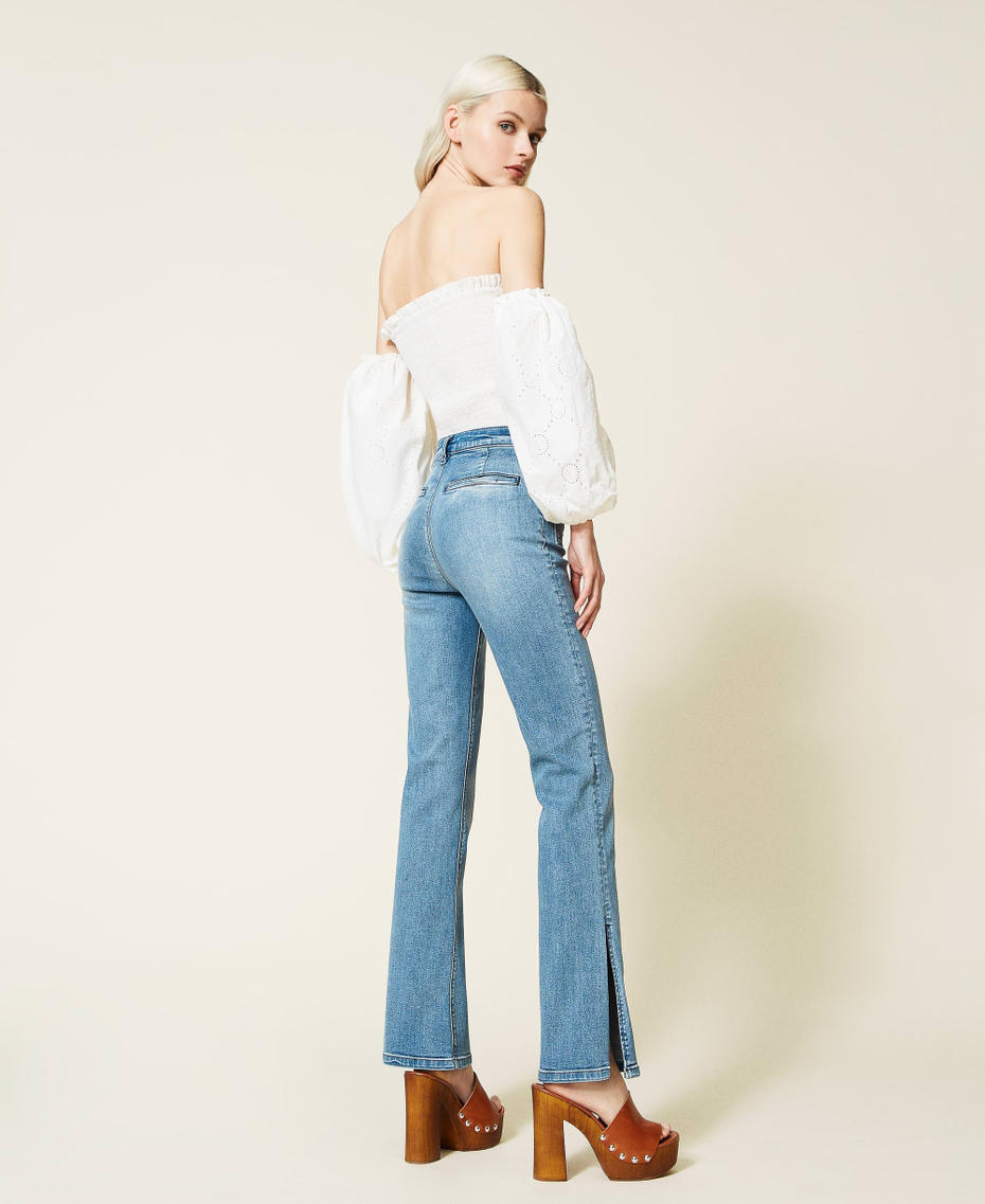 Flared jeans with appliqu&eacute;d pockets