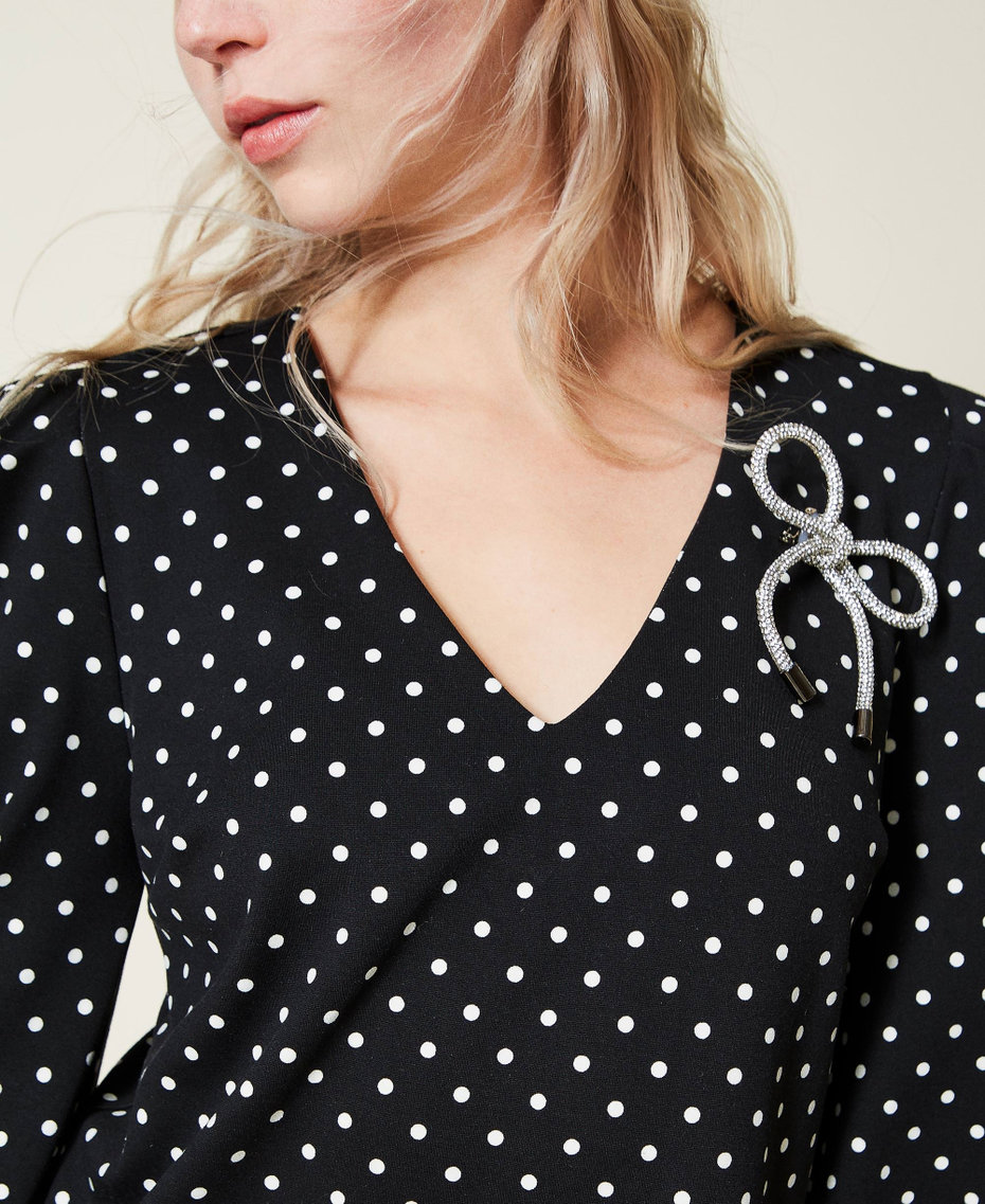 Short polka dot dress with brooch