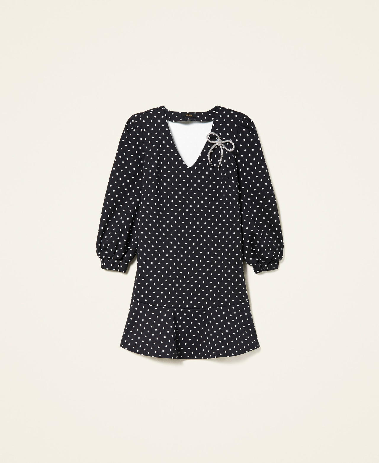 Short polka dot dress with brooch