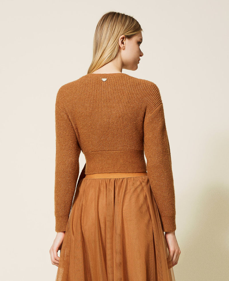 Short cardigan with criss-cross