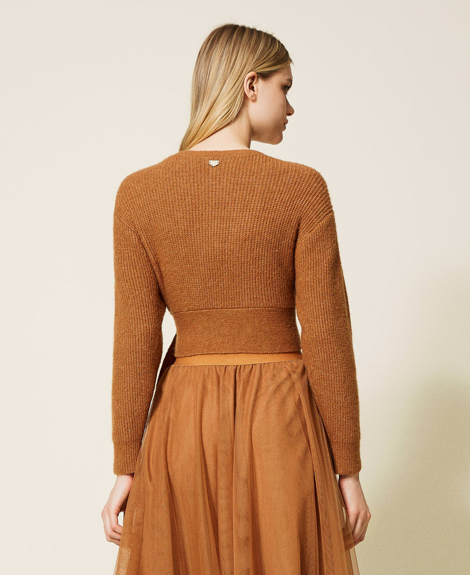 Short cardigan with criss-cross