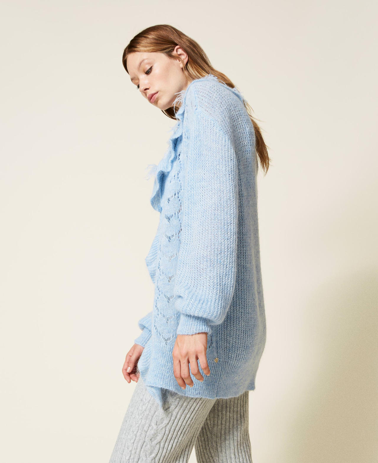 Oversized cardigan with feathers and rhinestones