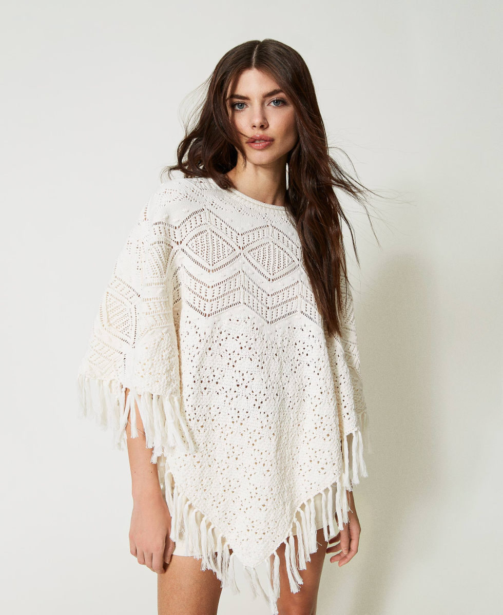 Knit poncho with fringes