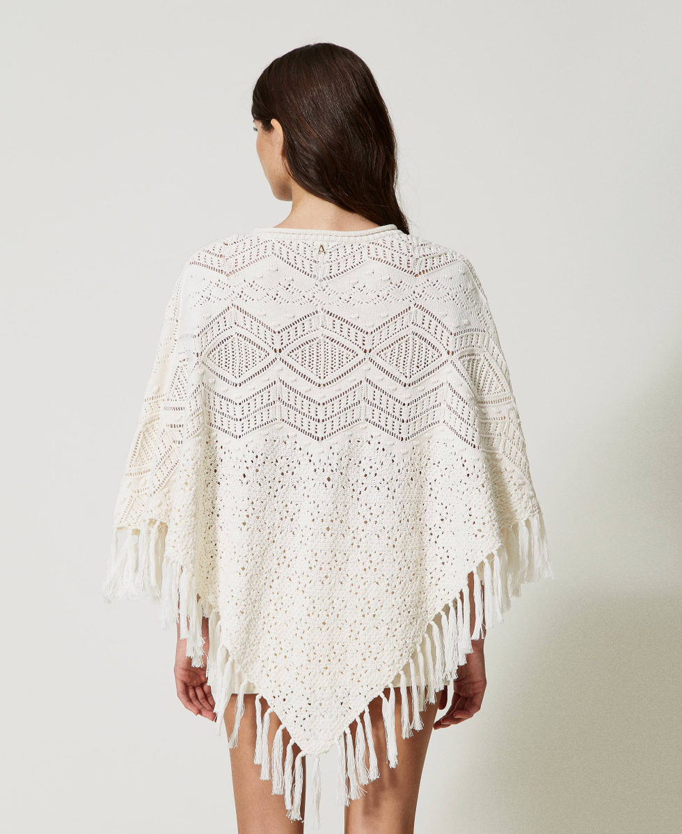 Knit poncho with fringes