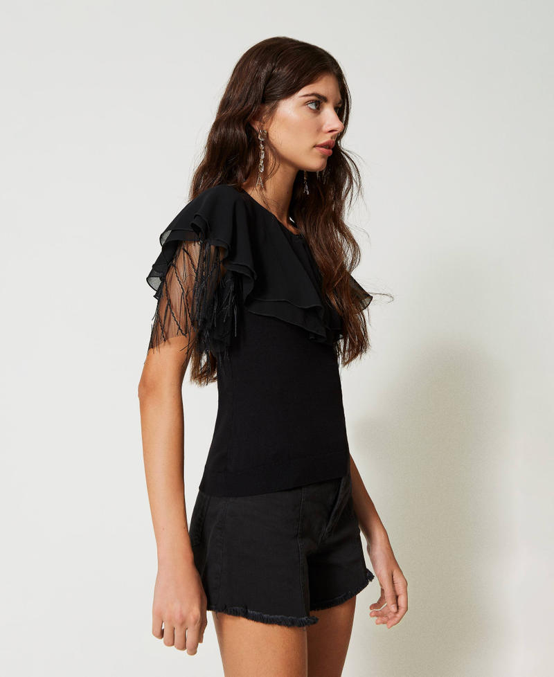 Knitted top with tulle and cape