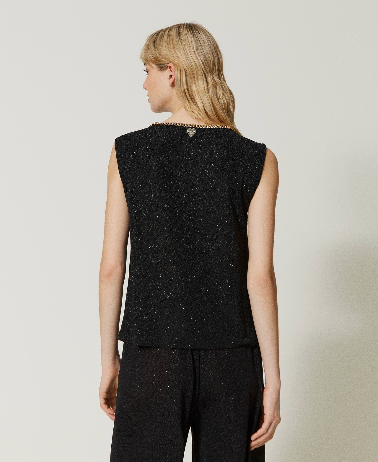 Top con catena décor