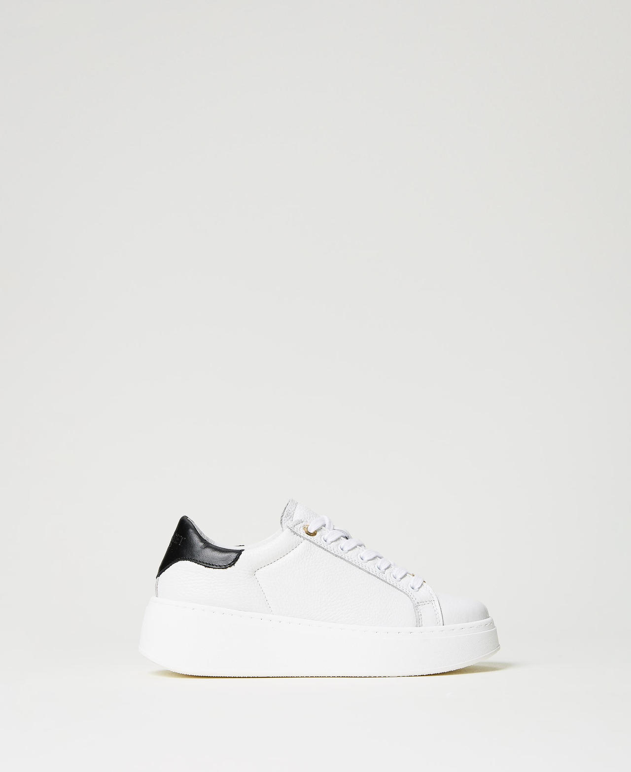 White trainers hotsell with black heel