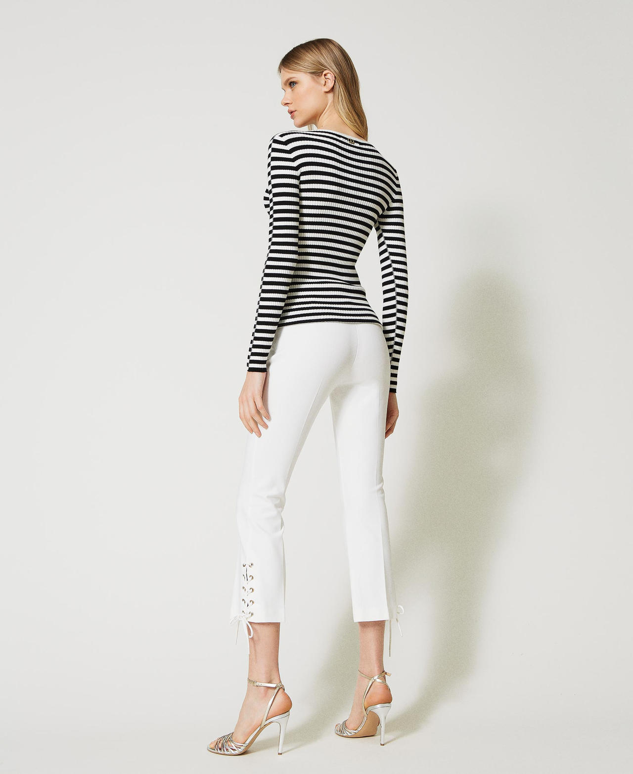 Trousers with eyelets and weaving