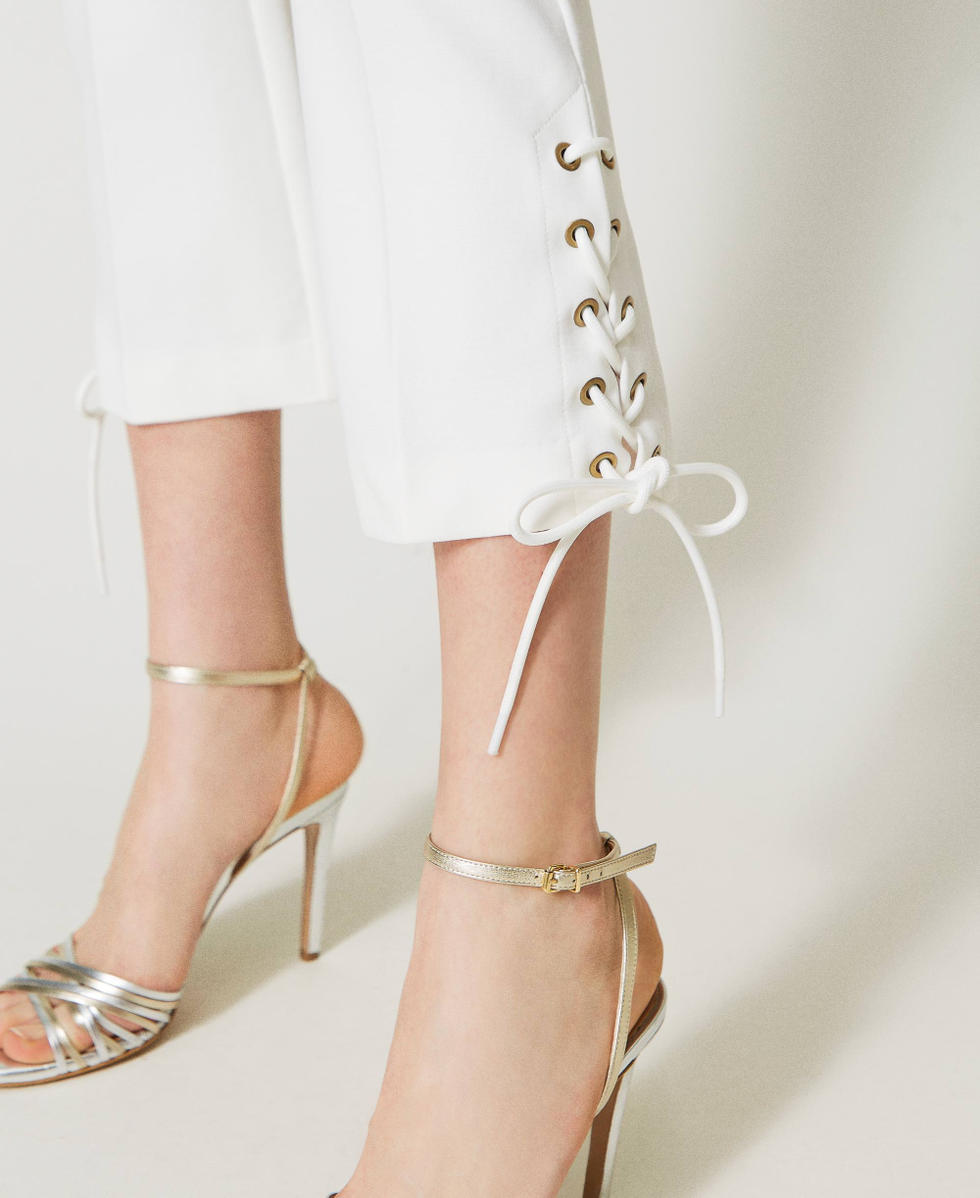 Trousers with eyelets and weaving