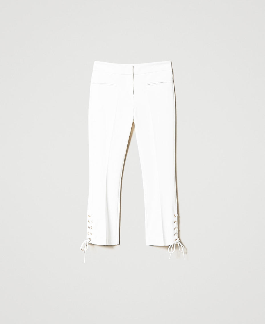 Trousers with eyelets and weaving