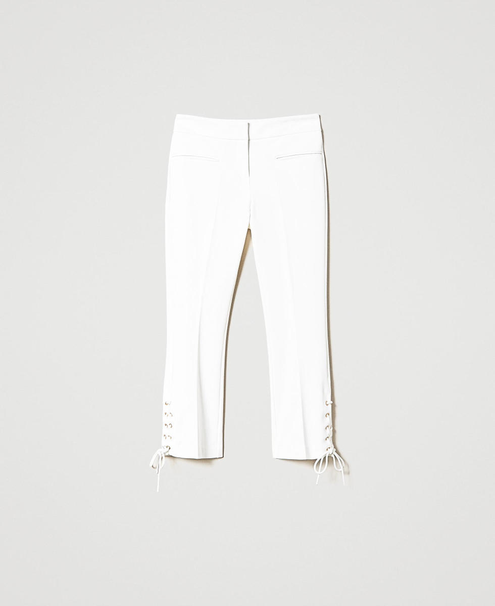 Trousers with eyelets and weaving