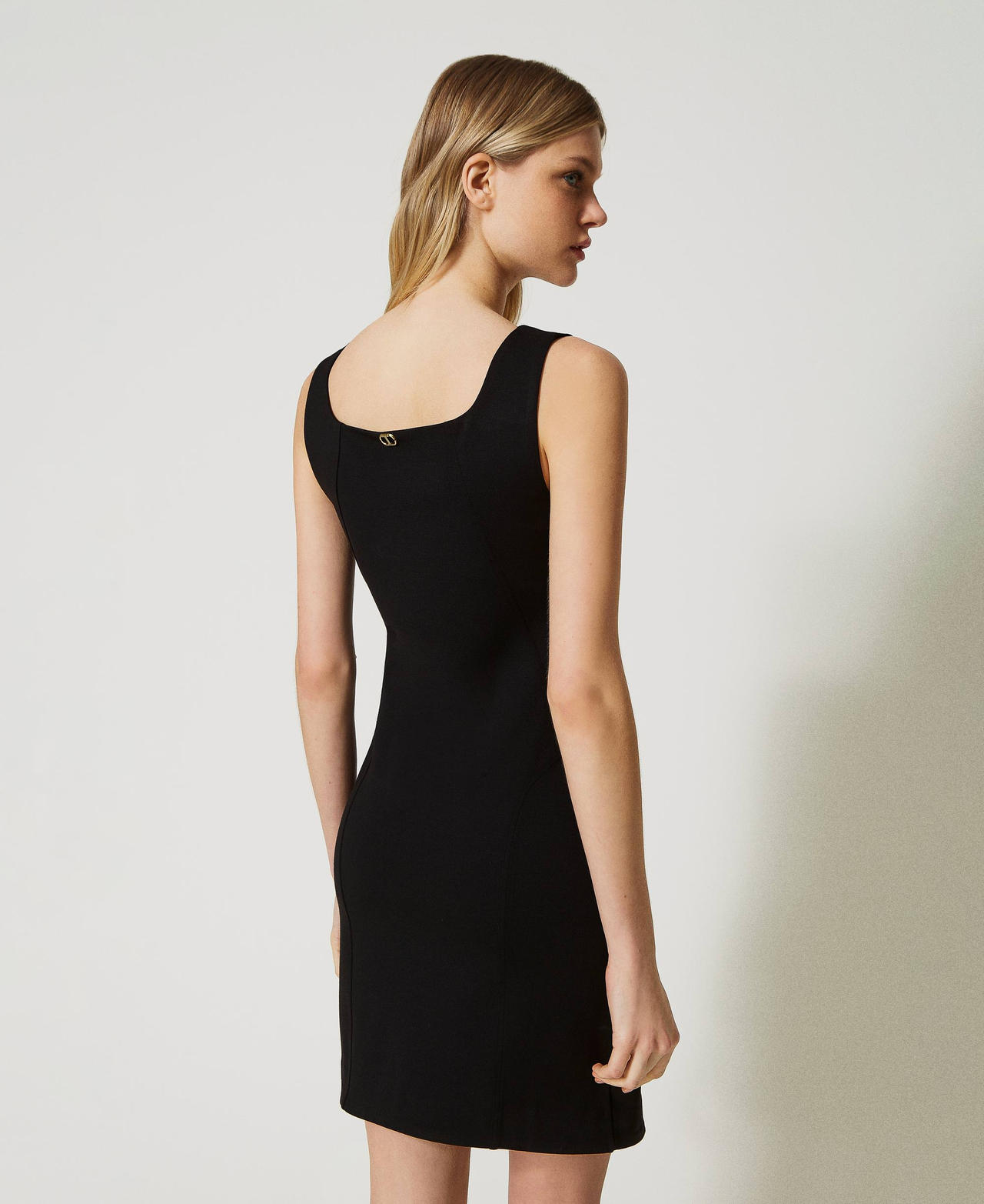 Dress with eyelets and weaving