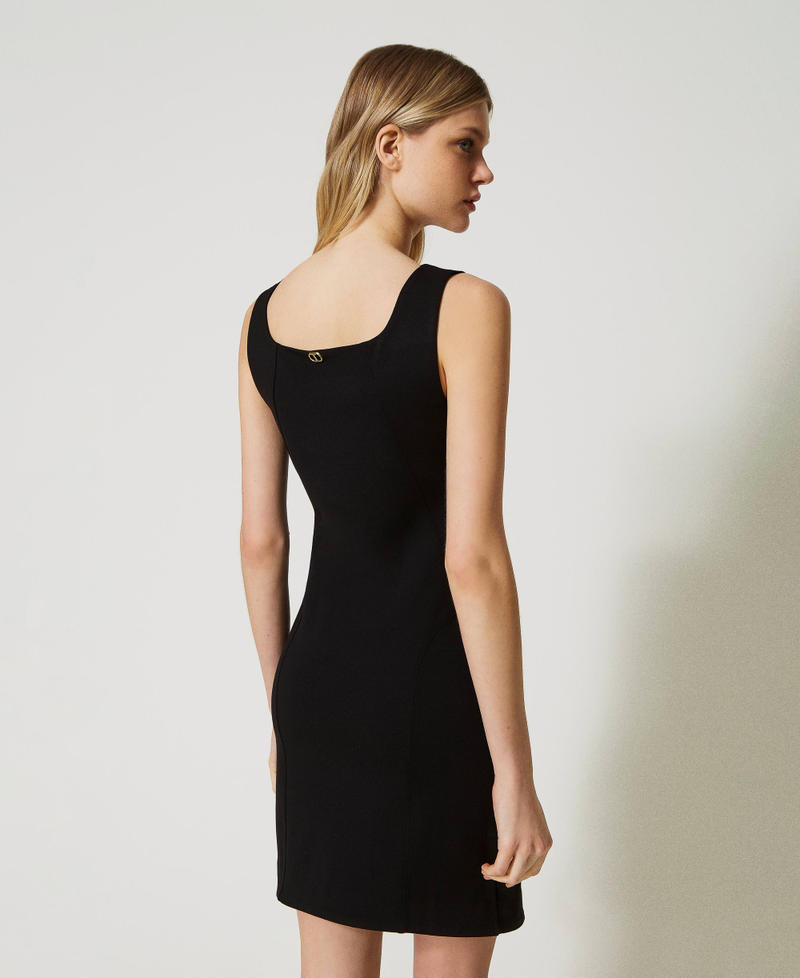 Dress with eyelets and weaving