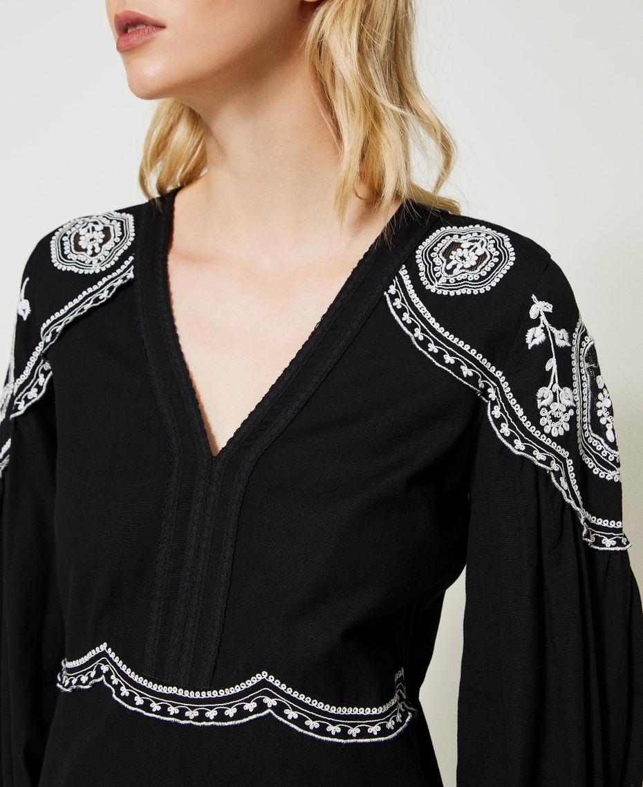 Dress with contrasting embroideries