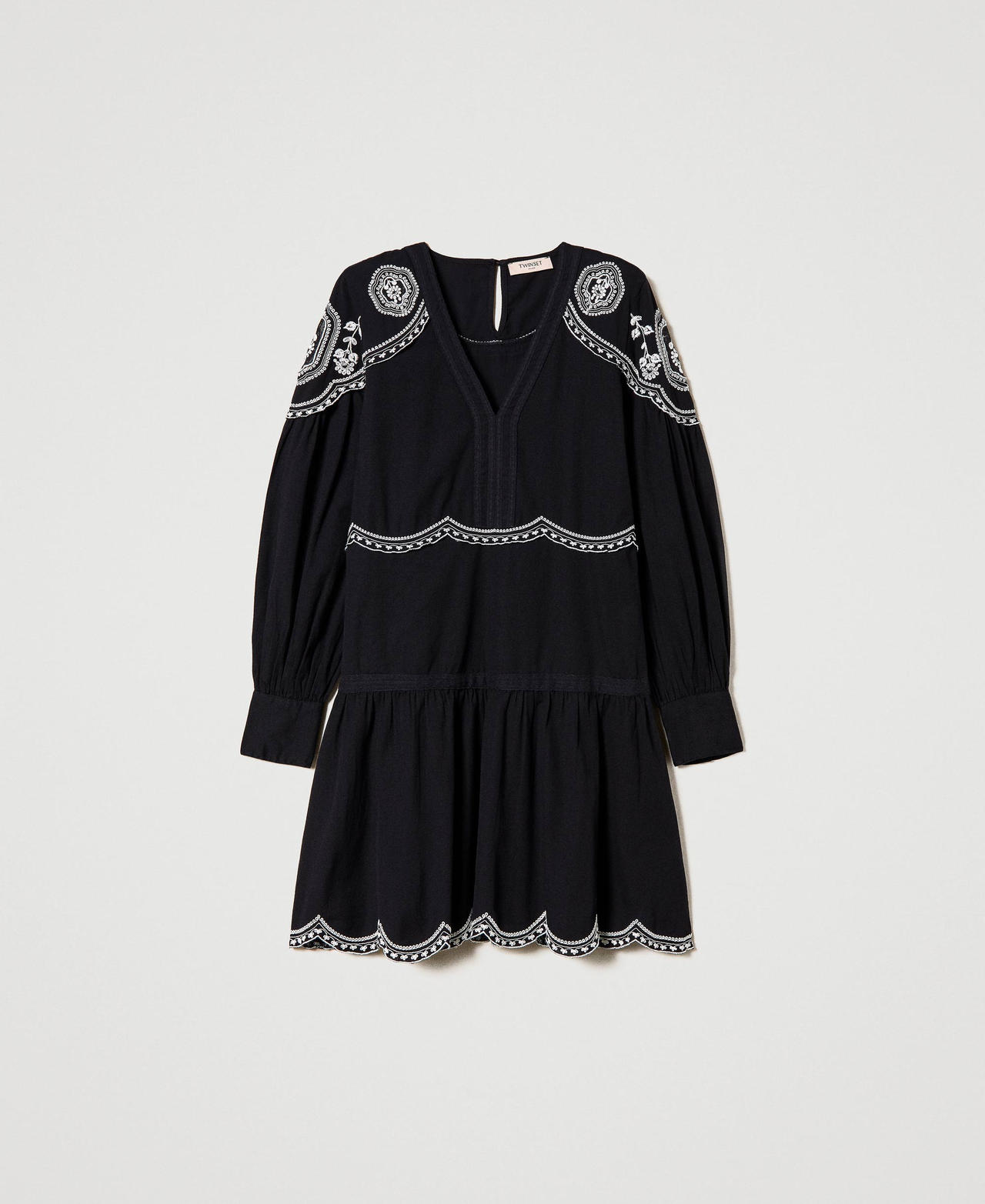 Dress with contrasting embroideries