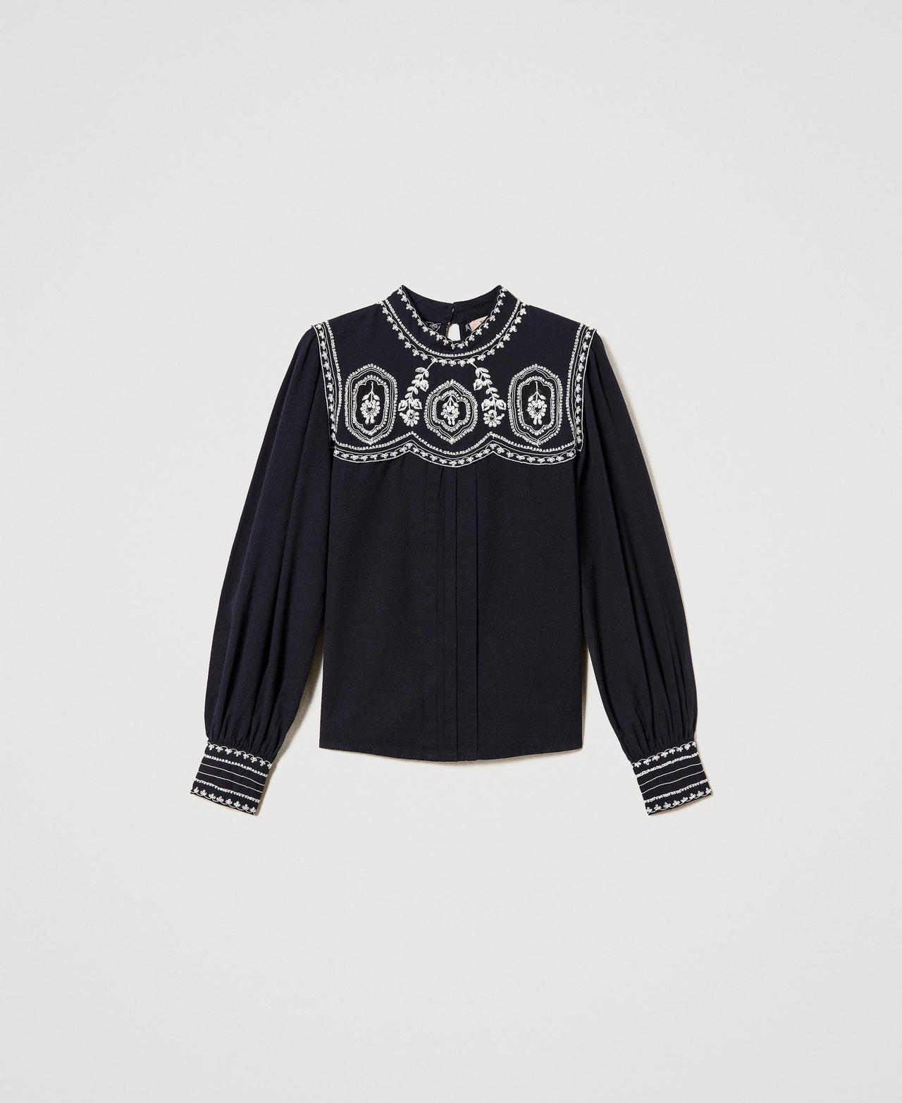 Blouse with contrasting embroideries