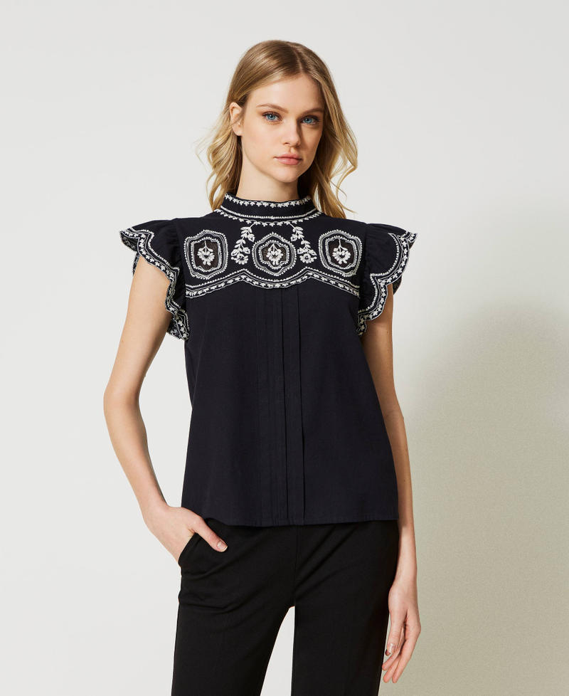 Top with contrasting embroideries