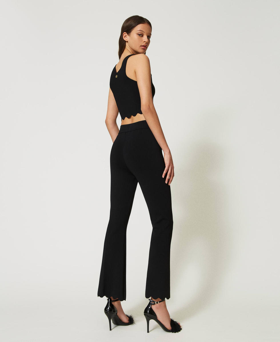 Flared knit trousers with scalloped hem