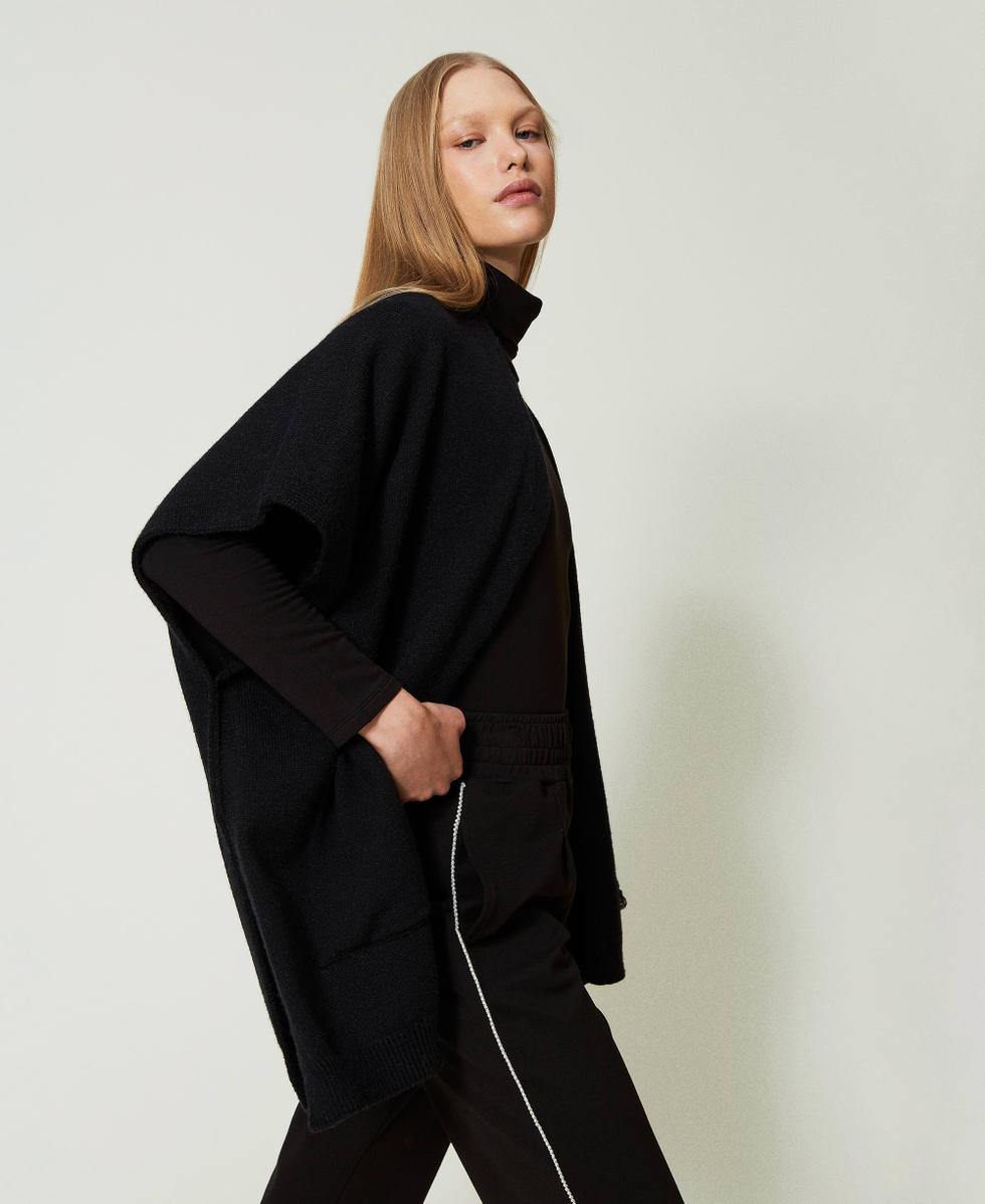 Open poncho with logo and fringes