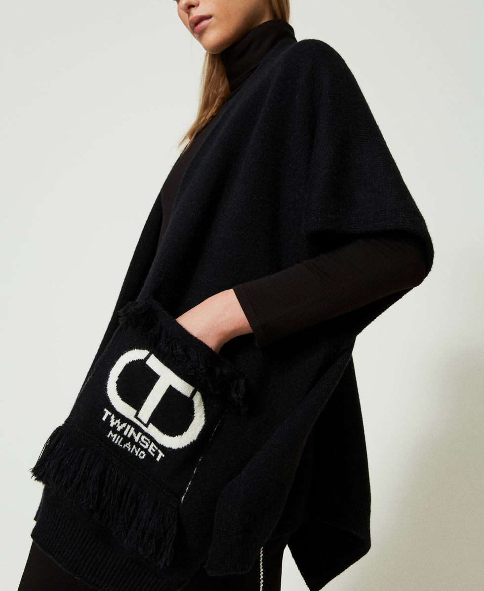 Open poncho with logo and fringes