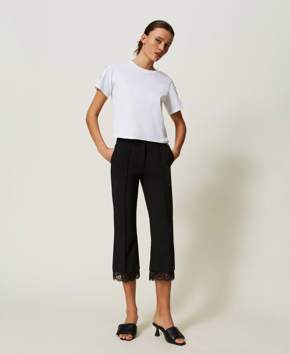 Cropped trousers with macram&eacute; lace