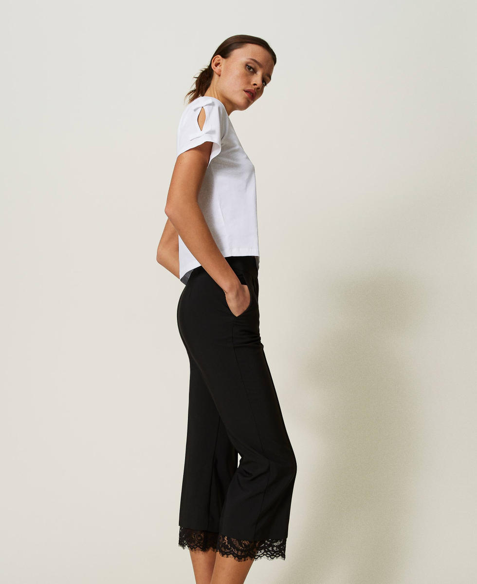 Cropped trousers with macram&eacute; lace