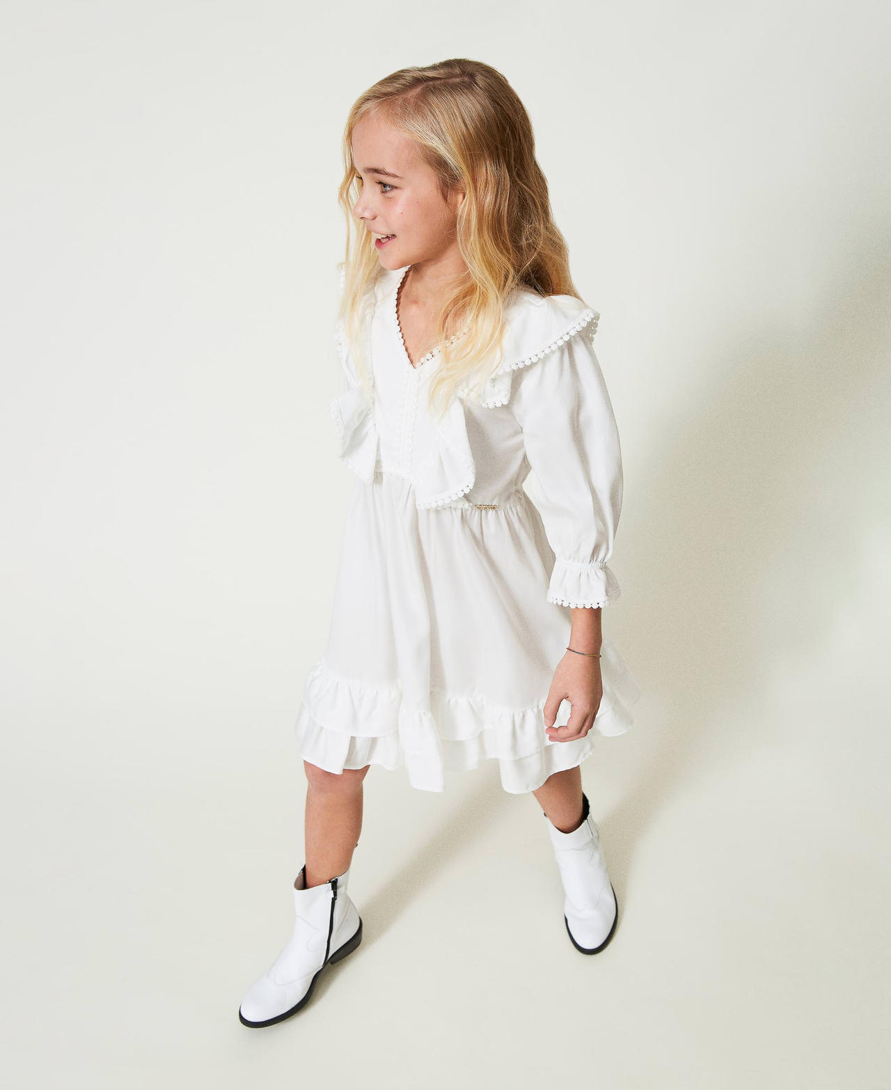 Short dress with ruffles and pompoms