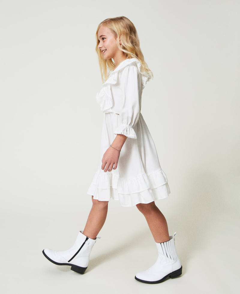 Short dress with ruffles and pompoms