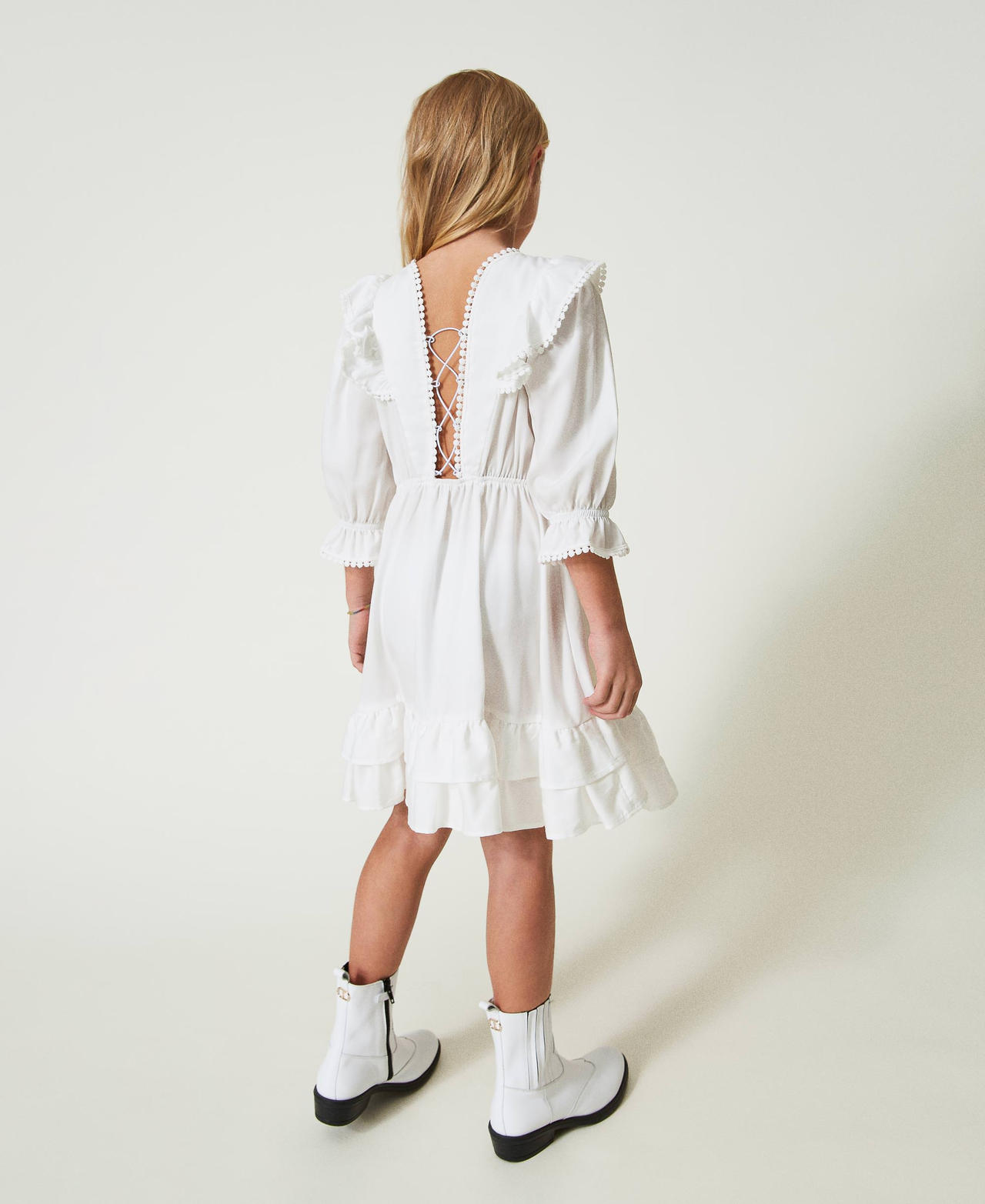 Short dress with ruffles and pompoms
