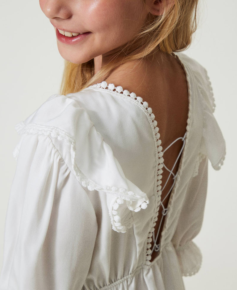 Short dress with ruffles and pompoms
