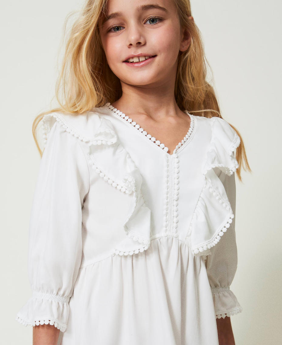Short dress with ruffles and pompoms
