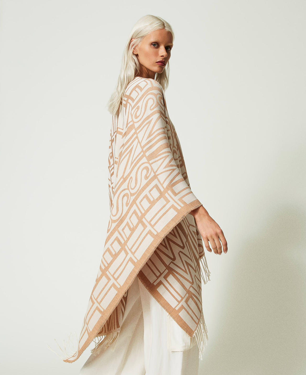 Jacquard poncho with logo and fringes