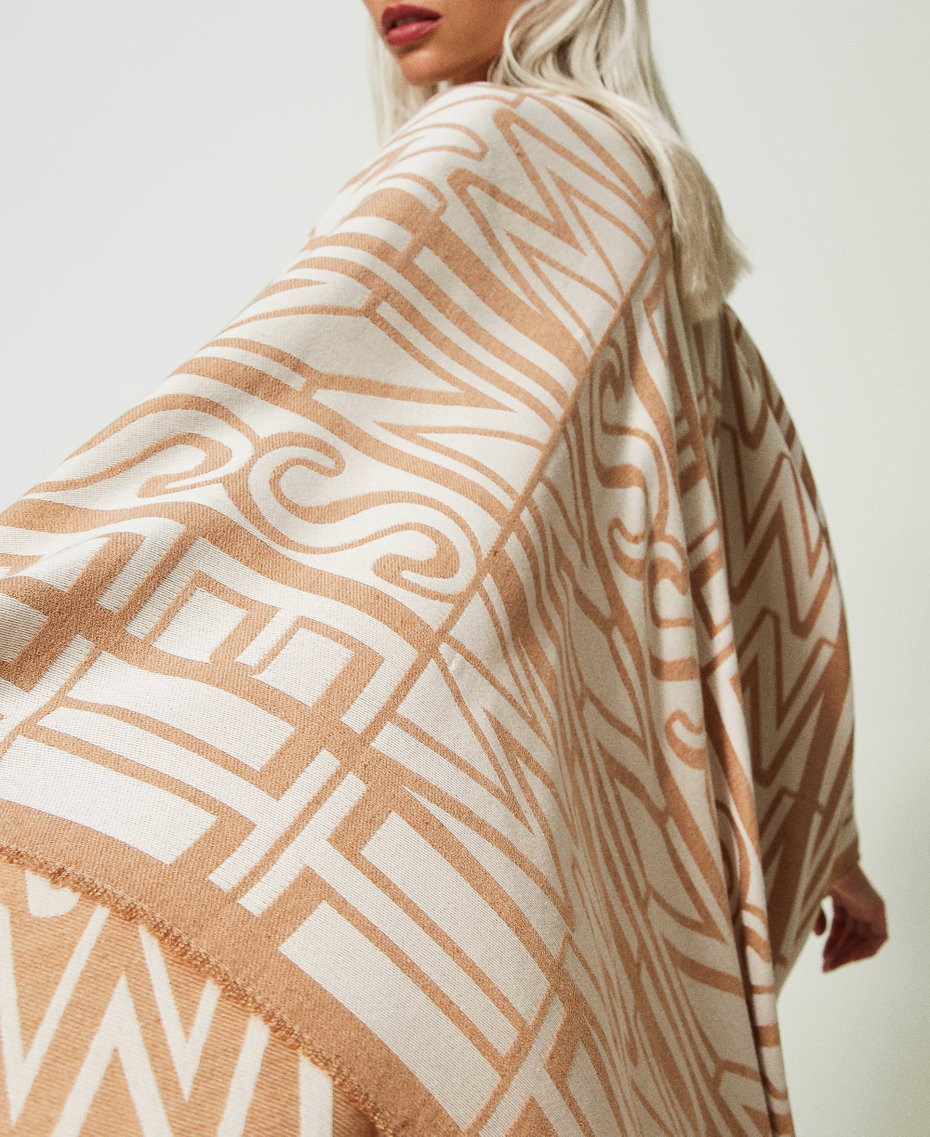 Jacquard poncho with logo and fringes