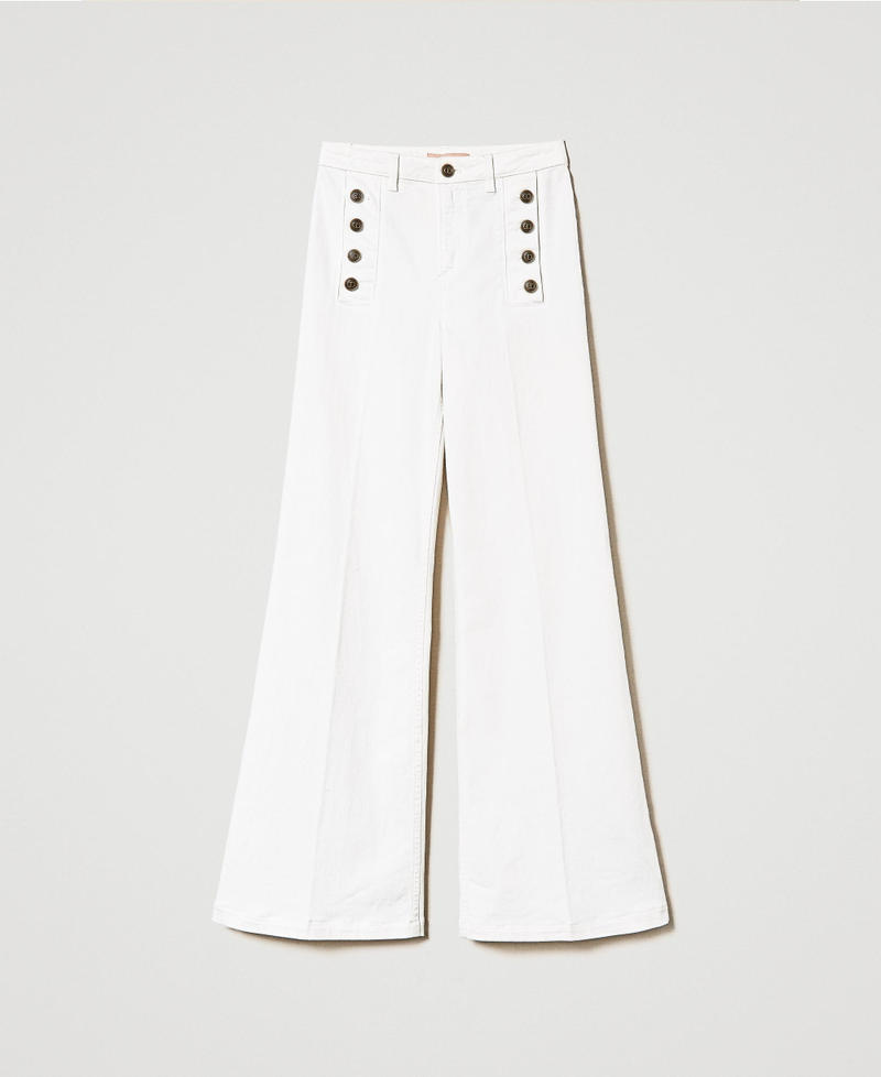 Flared white jeans with decorative buttons