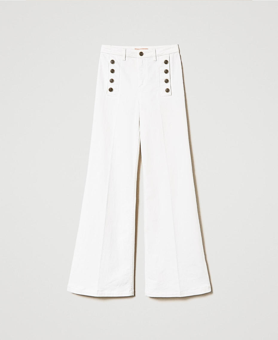 Flared white jeans with decorative buttons