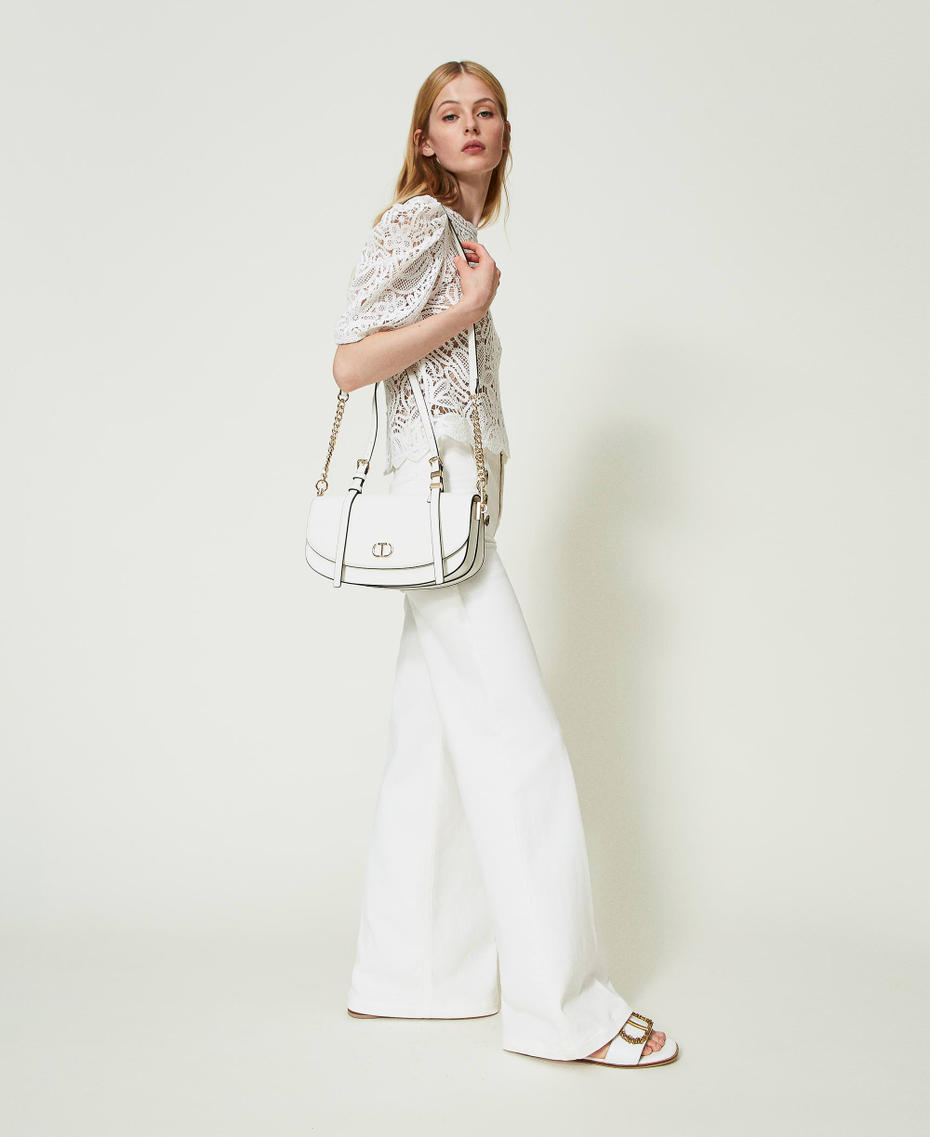 Flared white jeans with decorative buttons