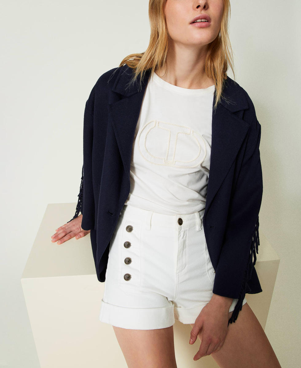 White denim shorts with decorative buttons