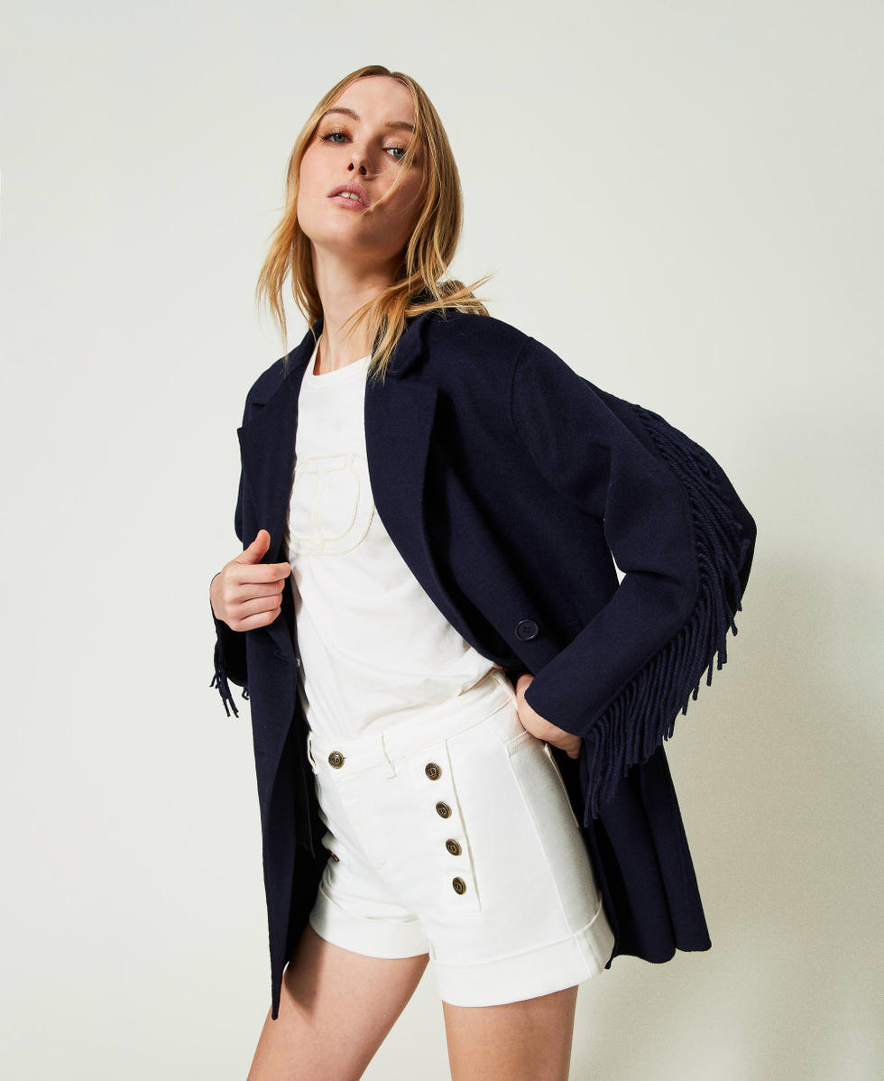 White denim shorts with decorative buttons