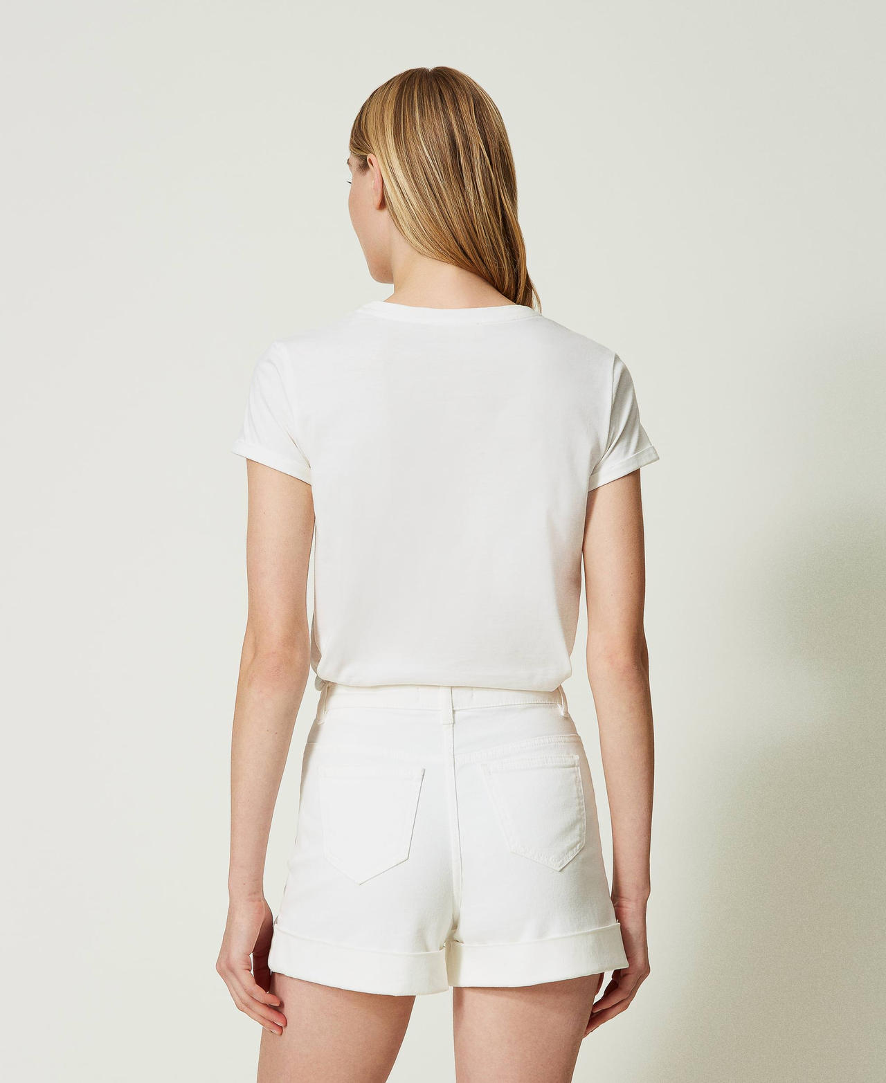 White denim shorts with decorative buttons