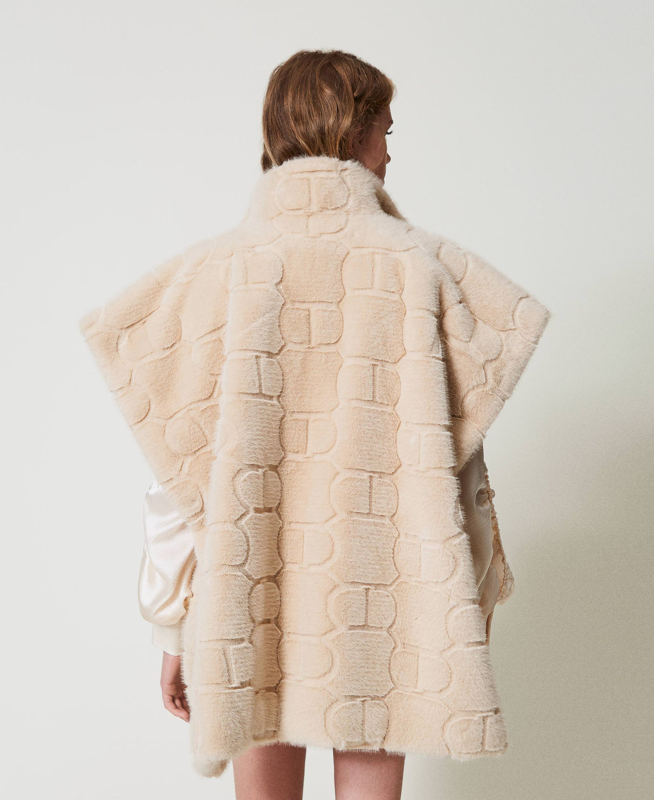 Faux fur poncho with logo