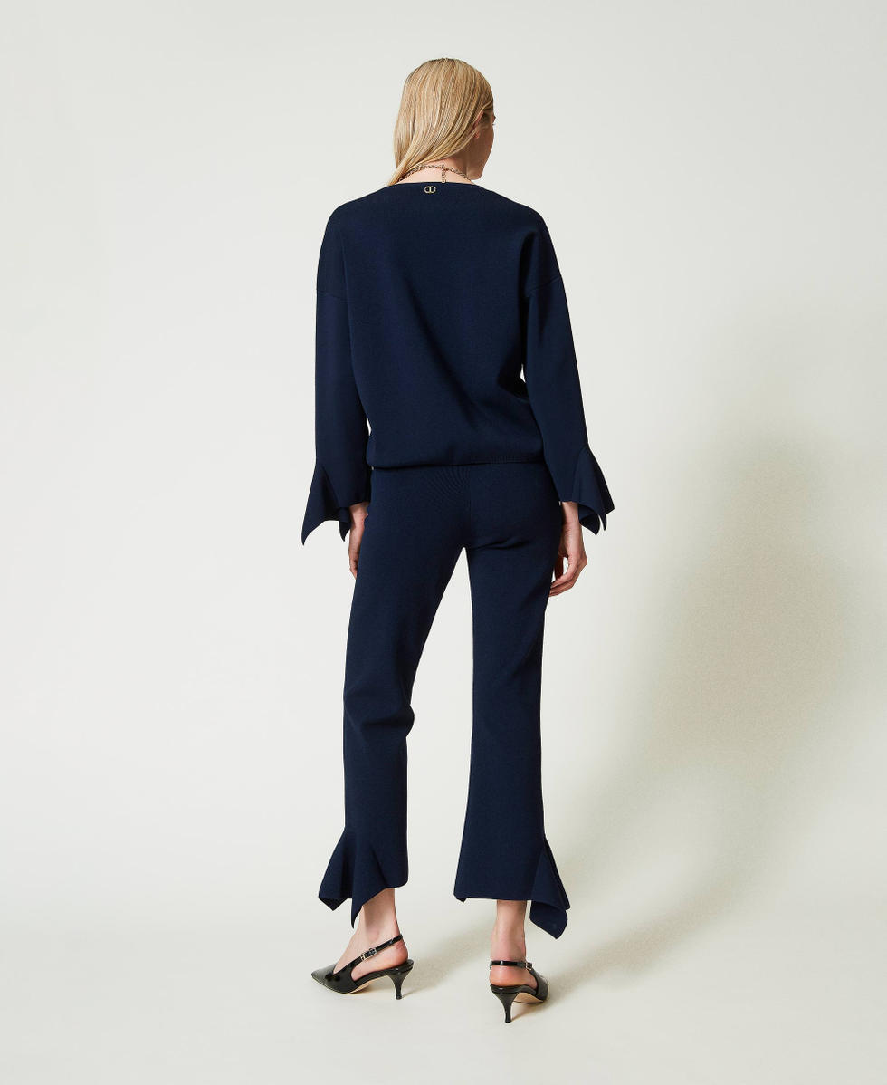 Flared knit trousers with ruffles
