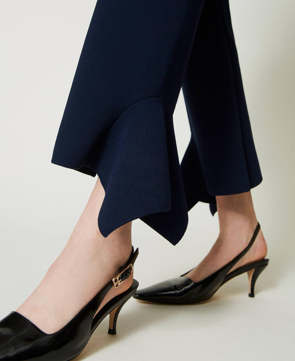 Flared knit trousers with ruffles