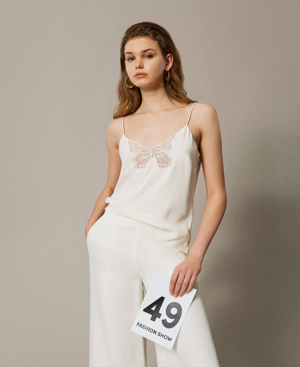 Top with an embroidered butterfly