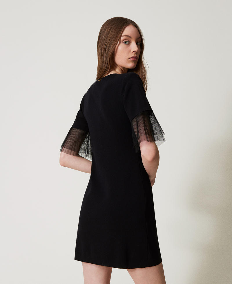 Short knit dress with tulle ruffles