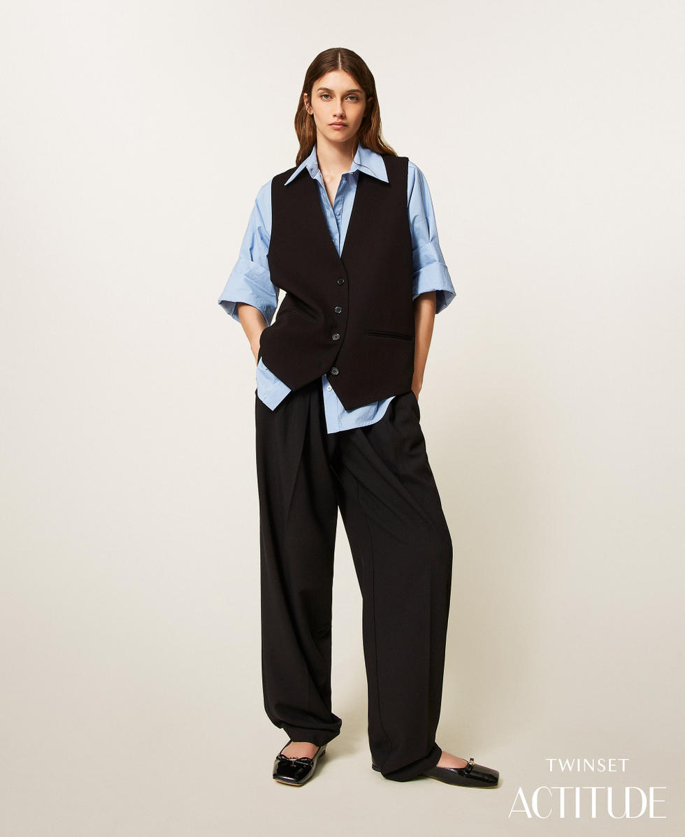 Trousers with asymmetrical pleats