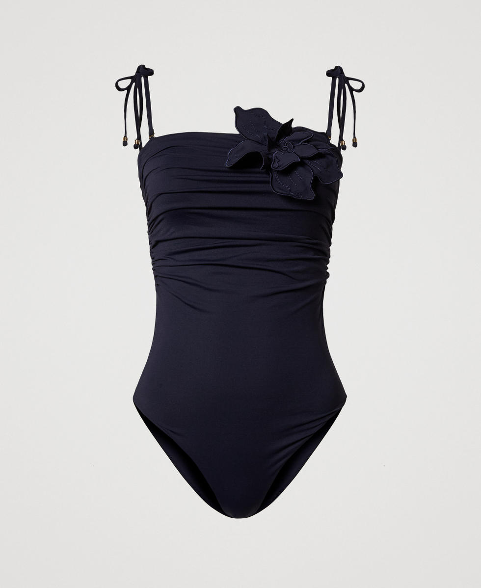 One-piece swimsuit with a floral patch