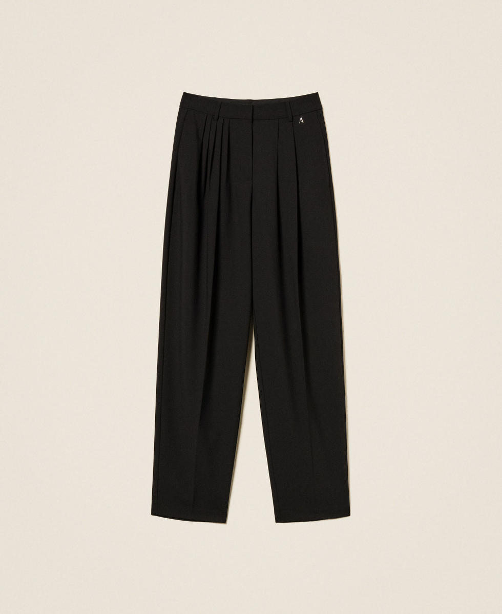 Trousers with asymmetrical pleats